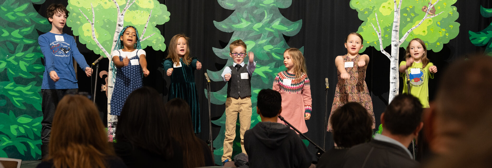 At the Champions for Children Breakfast 2024, Camp Fire Alaska's youth choir welcome guests with a song.